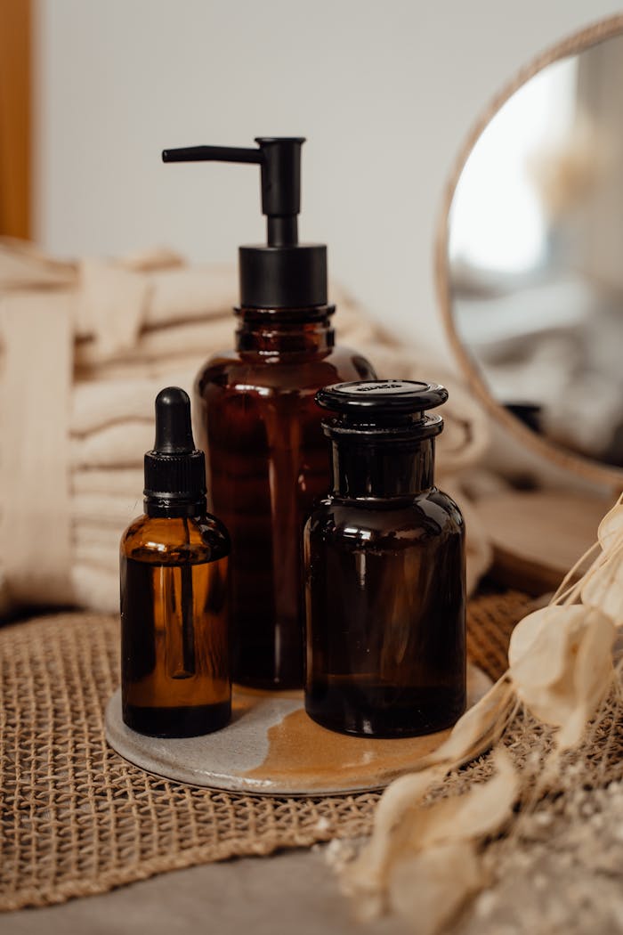 Stylish amber bottles on a rustic surface, perfect for organic skincare products.